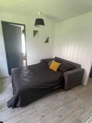 Un ou plusieurs lits dans un hébergement de l'établissement Petite maison chaleureuse des boucles de la Seine