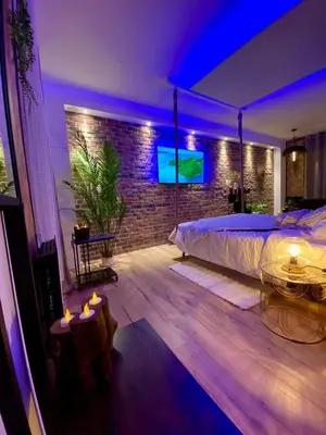 Un ou plusieurs lits dans un hébergement de l'établissement Saphir Spa - Sauna Balnéo Chromothérapie Massage