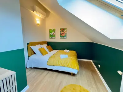 Un ou plusieurs lits dans un hébergement de l'établissement Maison 3ch - Cinéma - Game Room - Parking - Gare