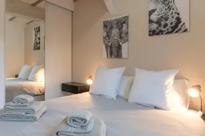 Un ou plusieurs lits dans un hébergement de l'établissement Villa Caron - Appartements haut de gamme avec chambre hyper centre