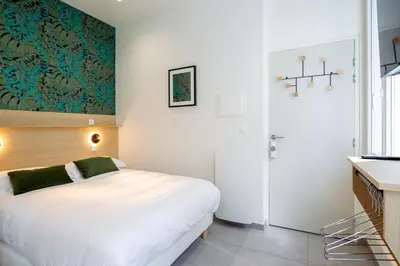 Un ou plusieurs lits dans un hébergement de l'établissement Appartement 1 proche de la gare et du centre ville