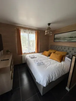 Un ou plusieurs lits dans un hébergement de l'établissement appartement ILLUSION