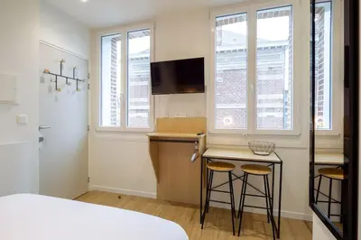 Un ou plusieurs lits dans un hébergement de l'établissement Appartement 5 proche de la gare et du centre ville