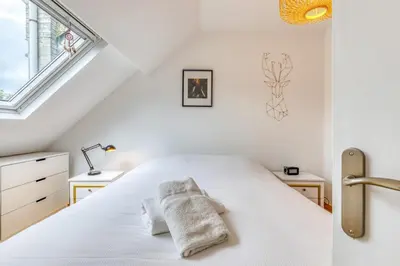 Un ou plusieurs lits dans un hébergement de l'établissement Ipso rooftop avec terrasse