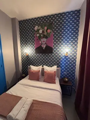 Un ou plusieurs lits dans un hébergement de l'établissement Hôtel Astrid