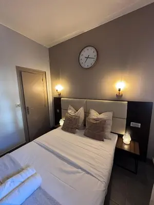 Un ou plusieurs lits dans un hébergement de l'établissement Hôtel Astrid
