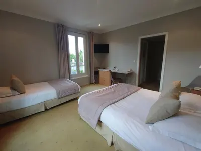 Un ou plusieurs lits dans un hébergement de l'établissement Hotel Le Continental