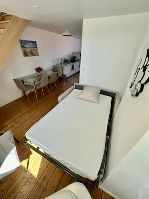 Un ou plusieurs lits dans un hébergement de l'établissement Le Duplex Appartement