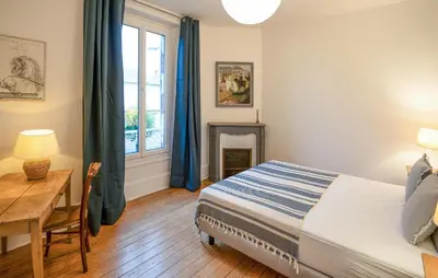 Un ou plusieurs lits dans un hébergement de l'établissement Charmante Maison De Ville