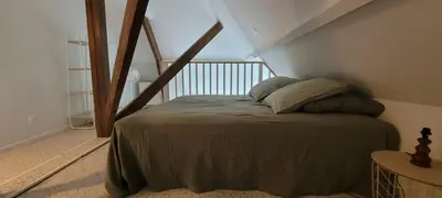 Un ou plusieurs lits dans un hébergement de l'établissement Le Birdie - Maison & Jardin à proximité de Chantilly