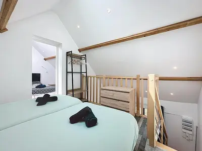 Un ou plusieurs lits dans un hébergement de l'établissement Maisonnette 49m2 à 5 minutes de chantilly