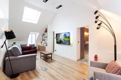 Coin salon dans l'établissement Suite Appart Place Versepuy