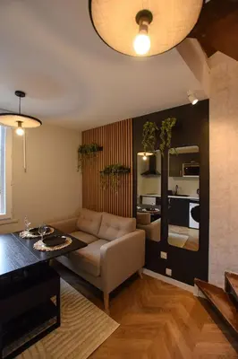 Coin salon dans l'établissement Le Cocon du Jardin duplex cosy, moderne et fibre