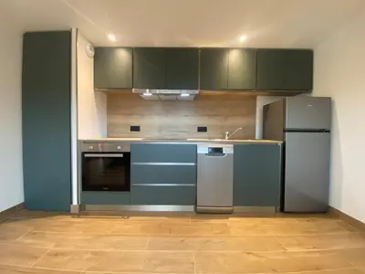 Cuisine ou kitchenette dans l'établissement Les Cottages du Manoir