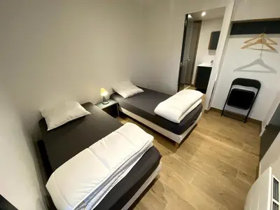 Un ou plusieurs lits dans un hébergement de l'établissement Les Cottages du Manoir