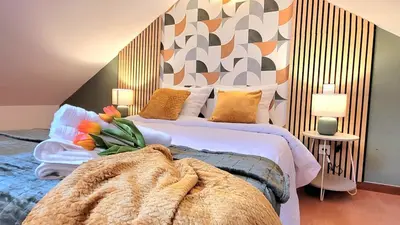 Un ou plusieurs lits dans un hébergement de l'établissement Le Duplex du Moulin - Maison T2 cosy centre-ville