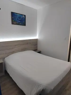 Un ou plusieurs lits dans un hébergement de l'établissement Alpha Hotel