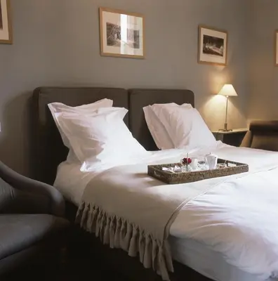 Un ou plusieurs lits dans un hébergement de l'établissement Hôtel La Licorne & Spa
