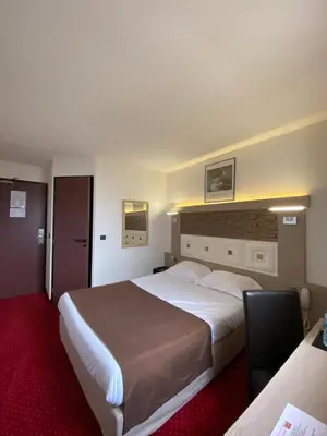 Un ou plusieurs lits dans un hébergement de l'établissement Kimotel Epône-Flins