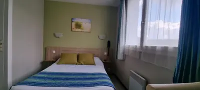 Un ou plusieurs lits dans un hébergement de l'établissement Hotel du Haut Marais