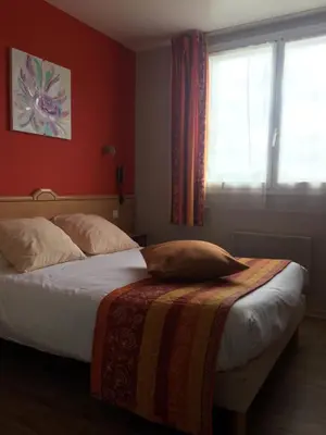 Un ou plusieurs lits dans un hébergement de l'établissement Hotel du Haut Marais