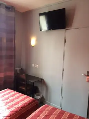 Un ou plusieurs lits dans un hébergement de l'établissement Hotel Les Arcades