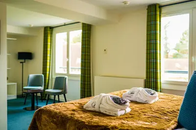 Un ou plusieurs lits dans un hébergement de l'établissement Hôtel-Restaurant Bel Ami