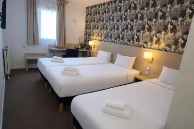 Un ou plusieurs lits dans un hébergement de l'établissement Logis Hotel Altina