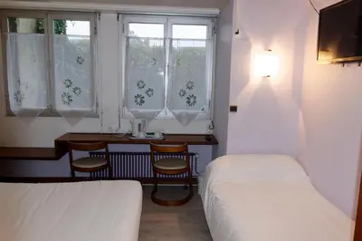 Un ou plusieurs lits dans un hébergement de l'établissement Hôtel le Relais