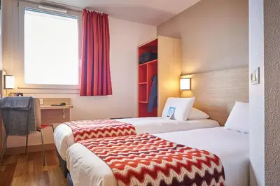Un ou plusieurs lits dans un hébergement de l'établissement Kyriad Rouen Sud - Val de Reuil