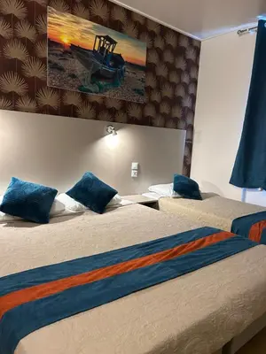 Un ou plusieurs lits dans un hébergement de l'établissement Hotel de Normandie
