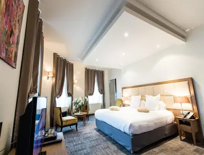 Un ou plusieurs lits dans un hébergement de l'établissement Hôtel Spa Marotte