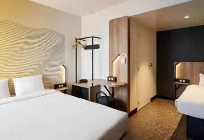 Un ou plusieurs lits dans un hébergement de l'établissement B&B HOTEL Cergy Saint Christophe