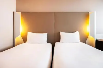 Un ou plusieurs lits dans un hébergement de l'établissement Campanile Hotel Beauvais