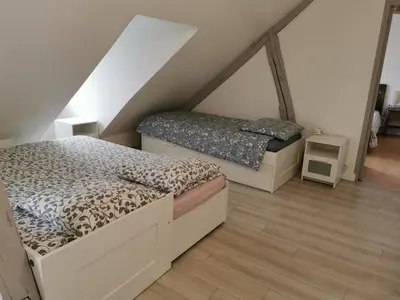 Un ou plusieurs lits dans un hébergement de l'établissement Appartements Up & Down by Beds76
