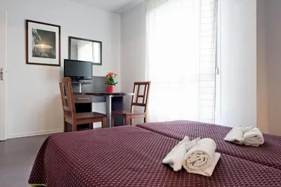 Un ou plusieurs lits dans un hébergement de l'établissement Residhotel Les Hauts d'Andilly