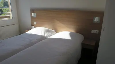 Un ou plusieurs lits dans un hébergement de l'établissement Brit Hotel Rouen Sud Val De Reuil