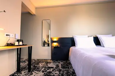 Un ou plusieurs lits dans un hébergement de l'établissement Logis Hôtel & Restaurant Le Vert Bocage