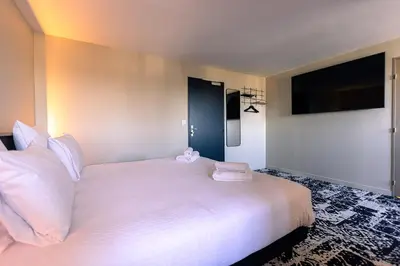 Un ou plusieurs lits dans un hébergement de l'établissement Logis Hôtel & Restaurant Le Vert Bocage