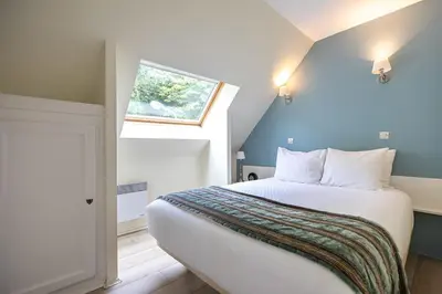 Un ou plusieurs lits dans un hébergement de l'établissement Club Wyndham Normandy
