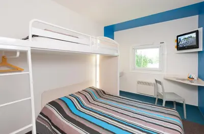 Un ou plusieurs lits dans un hébergement de l'établissement Eco hôtel Rouen Louviers Val de Reuil
