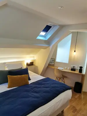 Un ou plusieurs lits dans un hébergement de l'établissement Hotel Restaurant La Musardiere