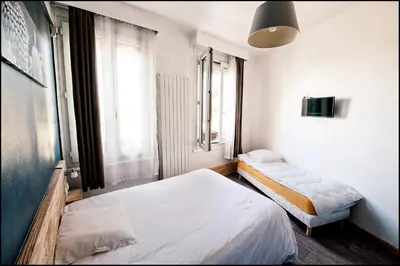 Un ou plusieurs lits dans un hébergement de l'établissement Hôtel du Nord