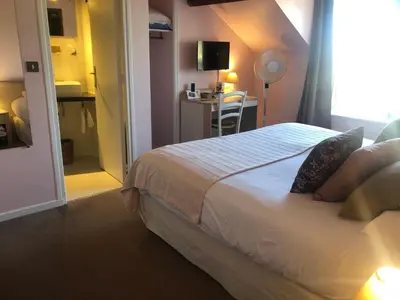 Un ou plusieurs lits dans un hébergement de l'établissement Hotel de L'Oise