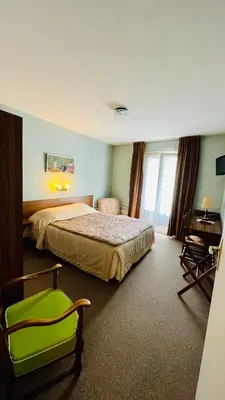 Un ou plusieurs lits dans un hébergement de l'établissement Hôtel le cygne