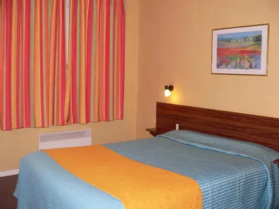 Un ou plusieurs lits dans un hébergement de l'établissement Hôtel le cygne