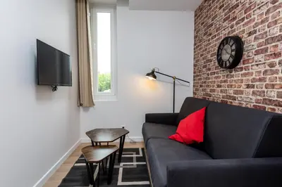 Coin salon dans l'établissement Location d'appartements - Cosysejour - Calme Fibre Netflix