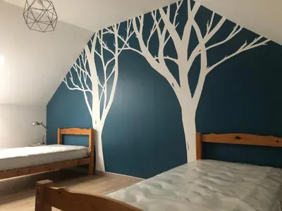 Un ou plusieurs lits dans un hébergement de l'établissement Maison chaleureuse à la campagne