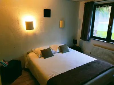Un ou plusieurs lits dans un hébergement de l'établissement Hôtel Restaurant l’Éolienne