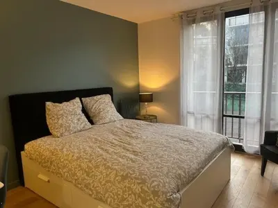 Un ou plusieurs lits dans un hébergement de l'établissement STUDIO PROCHE PARIS VERSAILLES